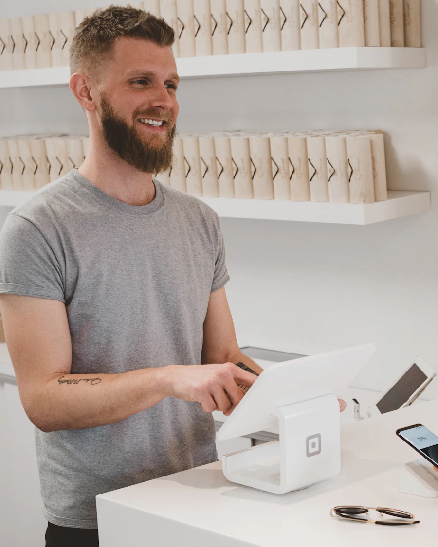 Shop owner taking a card payment from a customer