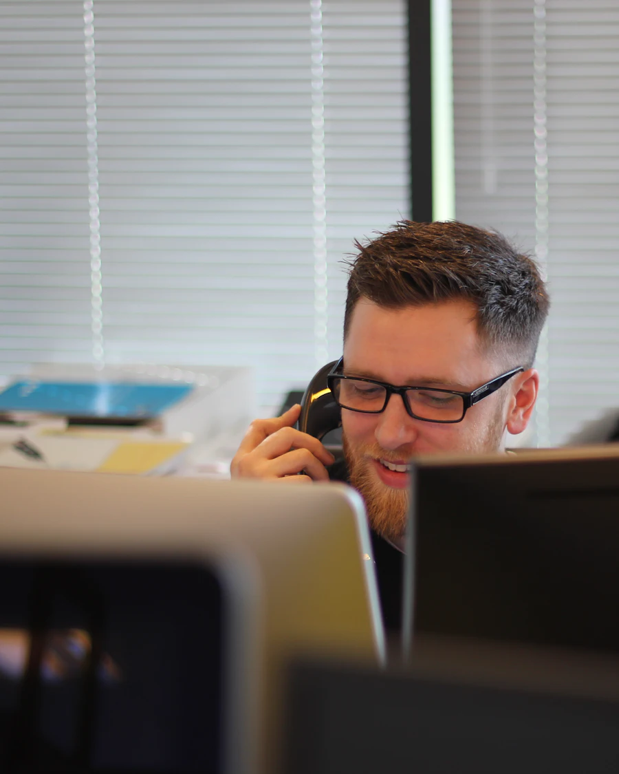 Support agent on a phone call at his desk